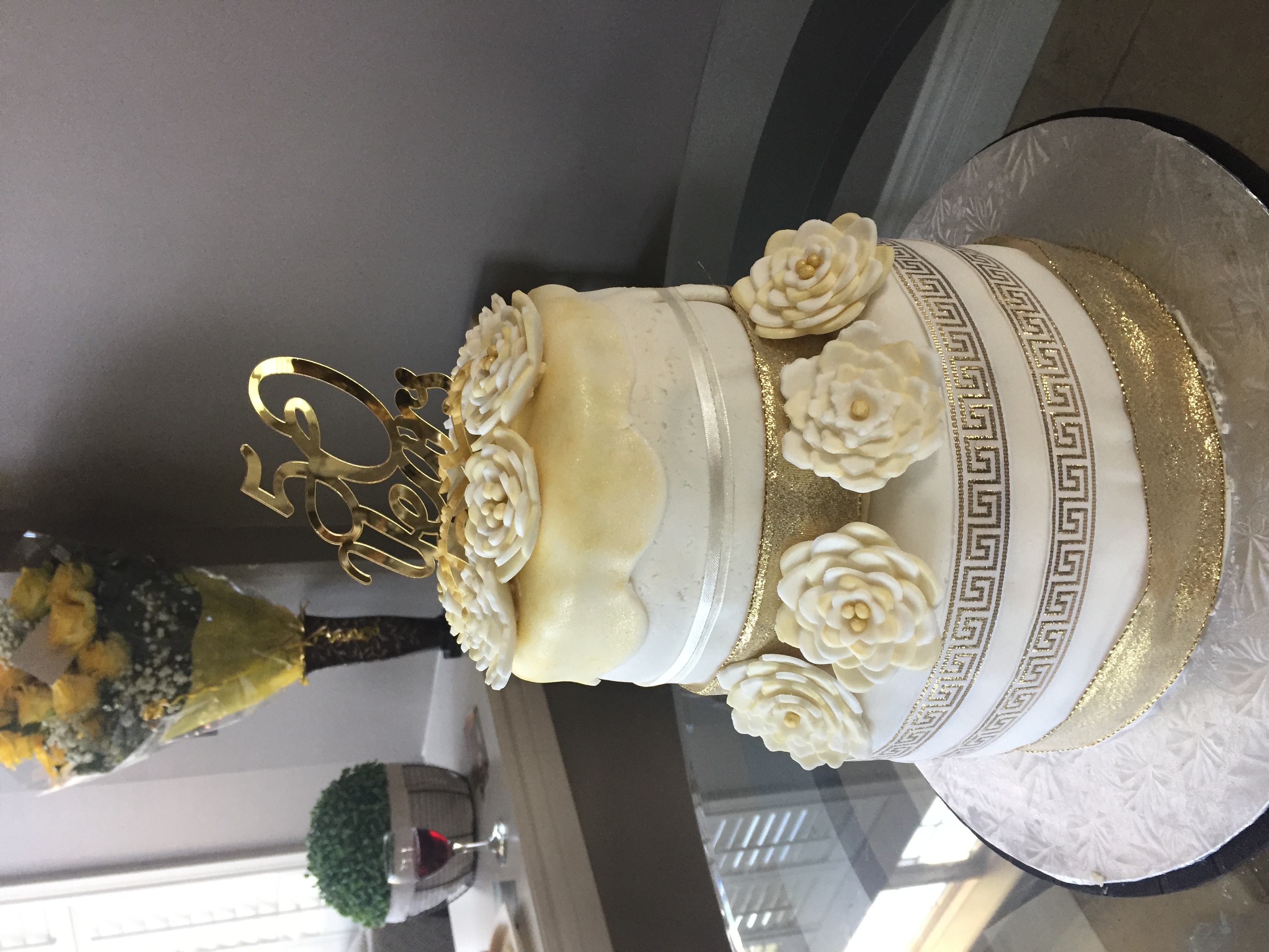 Elegant white and gold 50th anniversary cake